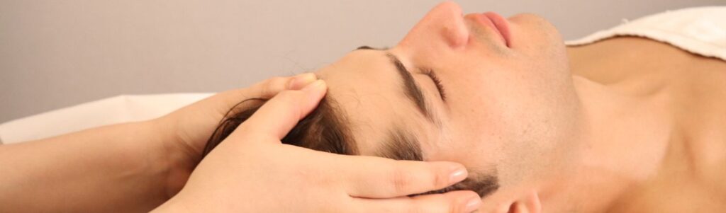 Therapist giving a deep tissue neck and shoulder massage to relieve desk job fatigue at Yinyang Spa Dubai.